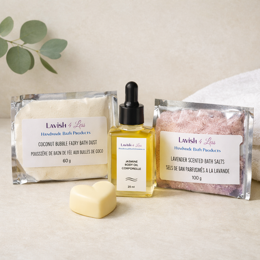 Lavish 4 Less handmade bath products arranged in a calm, minimalist flatlay featuring Coconut Bubble Fairy Bath Dust, Lavender Bath Salts, Jasmine Body Oil, and a heart‑shaped melt on a soft neutral background with natural light.