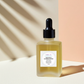 Unscented Body Oil in a glass dropper bottle styled with soft natural lighting and a clean spa‑like glow.