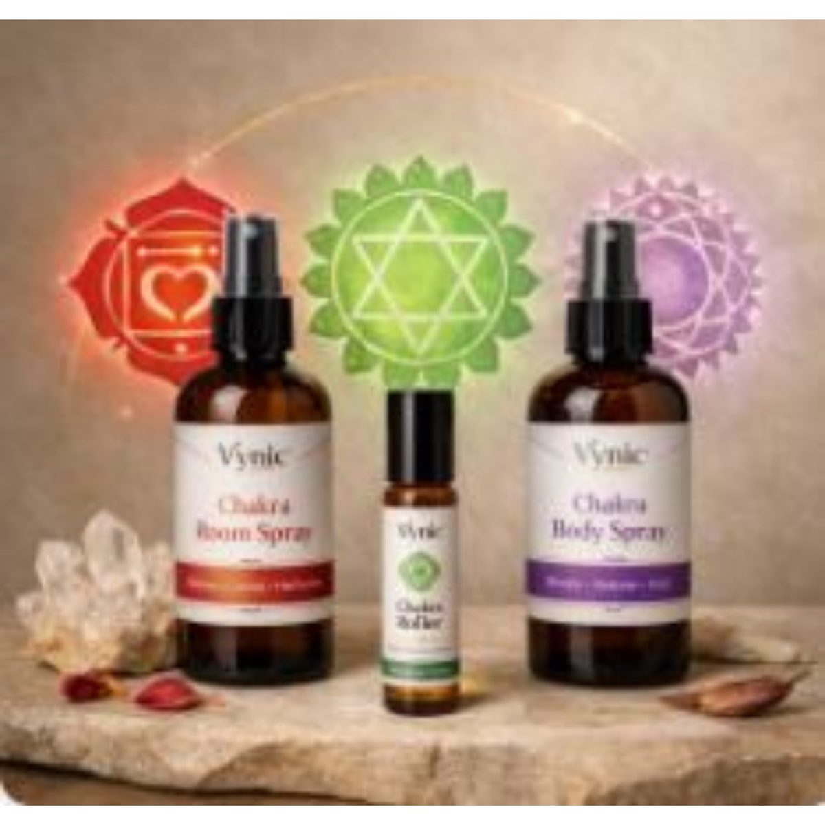Vynic Chakra Ritual Gift Set displayed in a soft spa‑style scene with body spray, room spray, and roller bottle arranged in a balanced layout. Subtle chakra symbols glow behind the products, with minimal props for a clean, calming aesthetic.